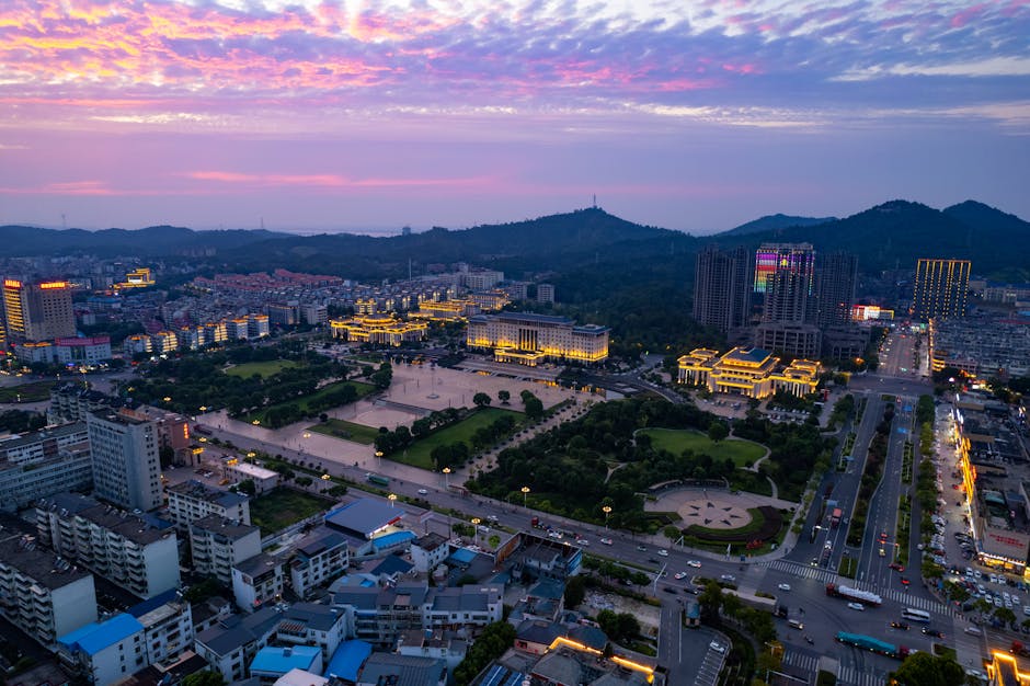 A stunning evening aerial view of Jiujiang, China with its illuminated streets and vibrant skyline.