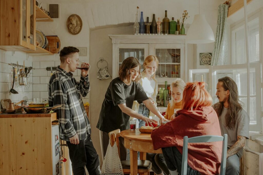 Junge Leute, Studenten und Azubis, kochen gemeinsam in der K&uuml;che einer Berliner Wohngemeinschaft (WG), f&uuml;r die ein WBS gelten kann.
